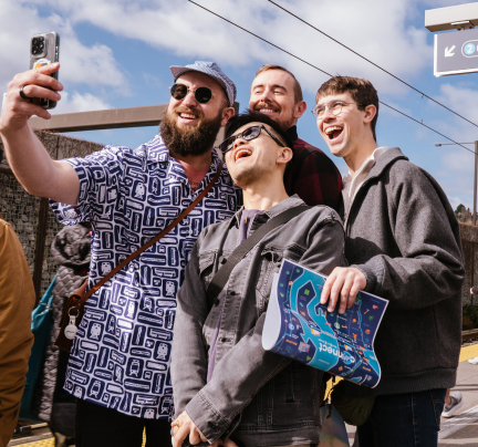 A group of jovial riders pose for a selfie.